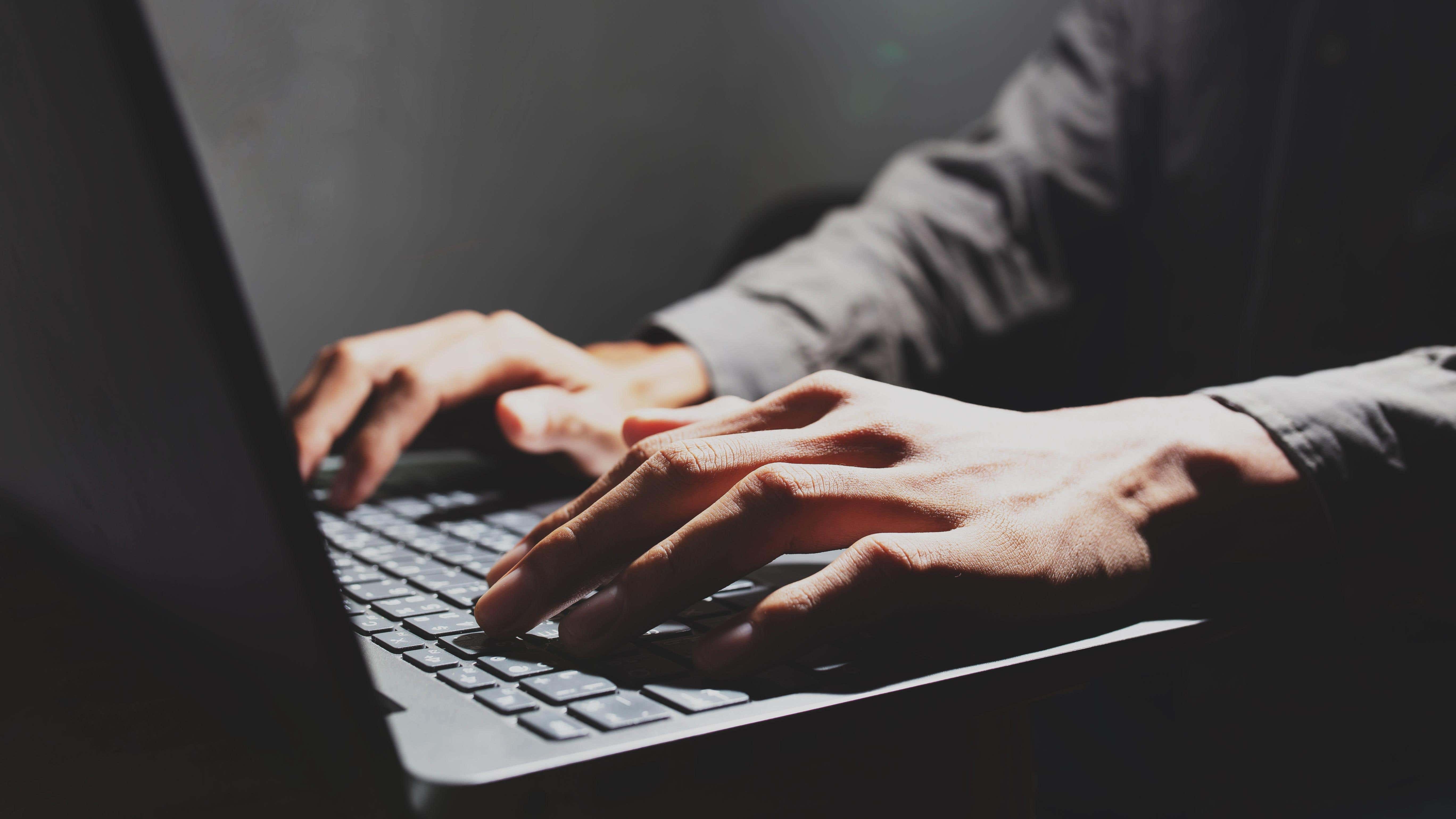 Photo of hands on laptop keyboard